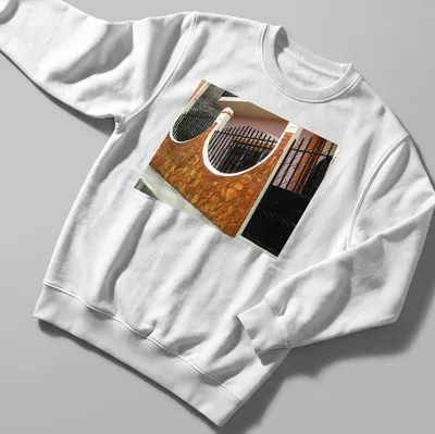 Photographic print of a Guatemalan home exterior in warm colors — printed on a unisex sweatshirt