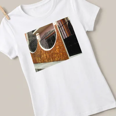 Photographic print of a Guatemalan home exterior in warm colors — printed on a women's shirt