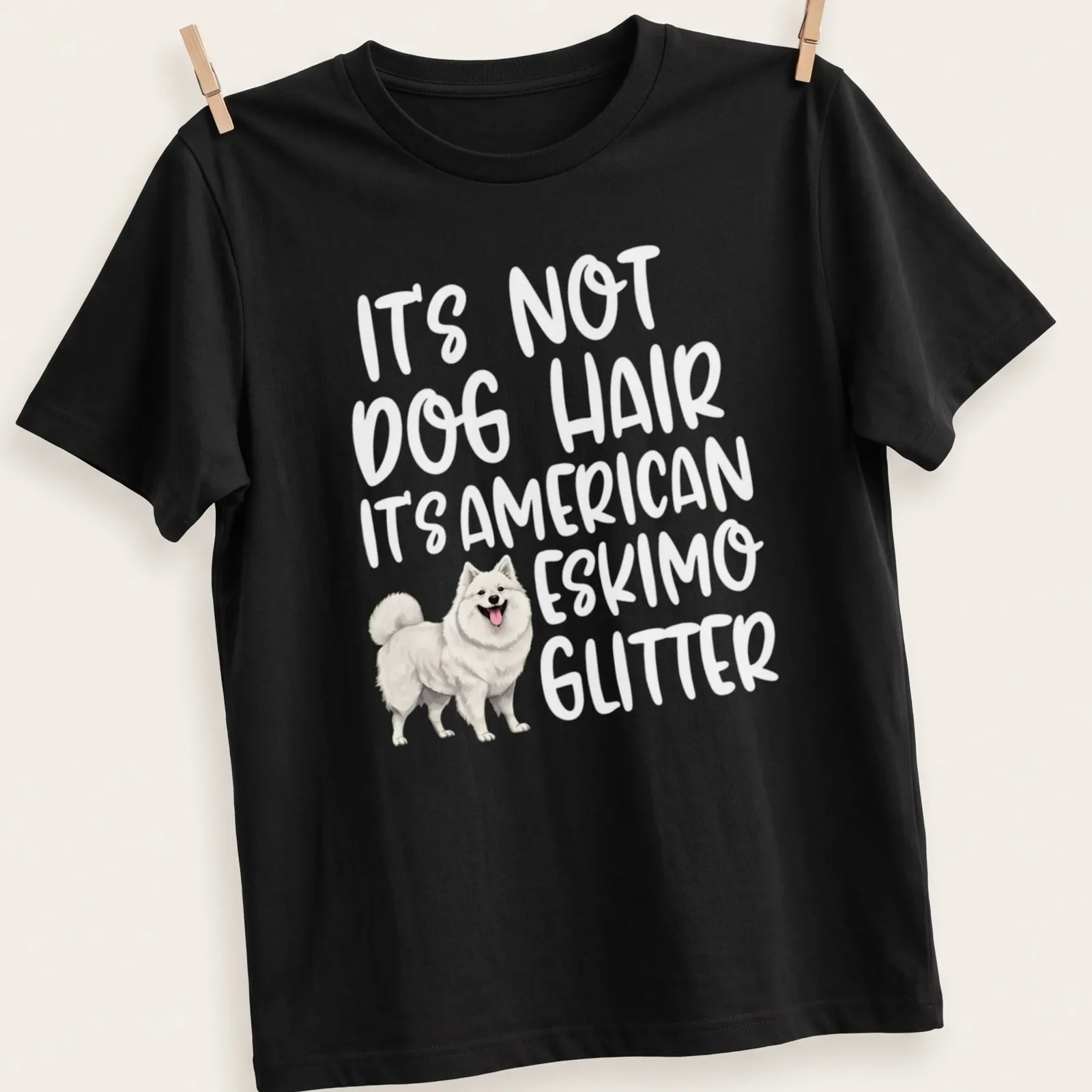 Illustrative t-shirt with an American Eskimo Dog and the text: It's Not Dog Hair It's American Eskimo Glitter — printed on a unisex t-shirt