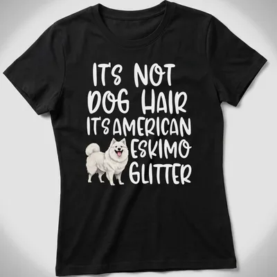 Illustrative t-shirt with an American Eskimo Dog and the text: It's Not Dog Hair It's American Eskimo Glitter — printed on a women's shirt