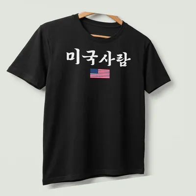 American Flag T-shirt featuring clean modern design with printed text '미국사람' — printed on a unisex t-shirt (angled view)