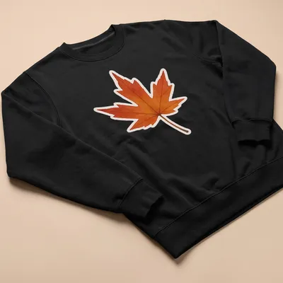 Watercolor design of an Amur maple leaf in orange, yellow, and brown — printed on a unisex sweatshirt