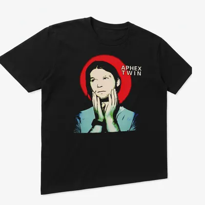Abstract Aphex Twin graphic T-shirt featuring bold red, white, blue, and green design — printed on a unisex t-shirt (angled view)