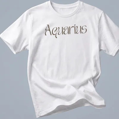Elegant script reading Aquarius in brown on a celestial-themed T-shirt