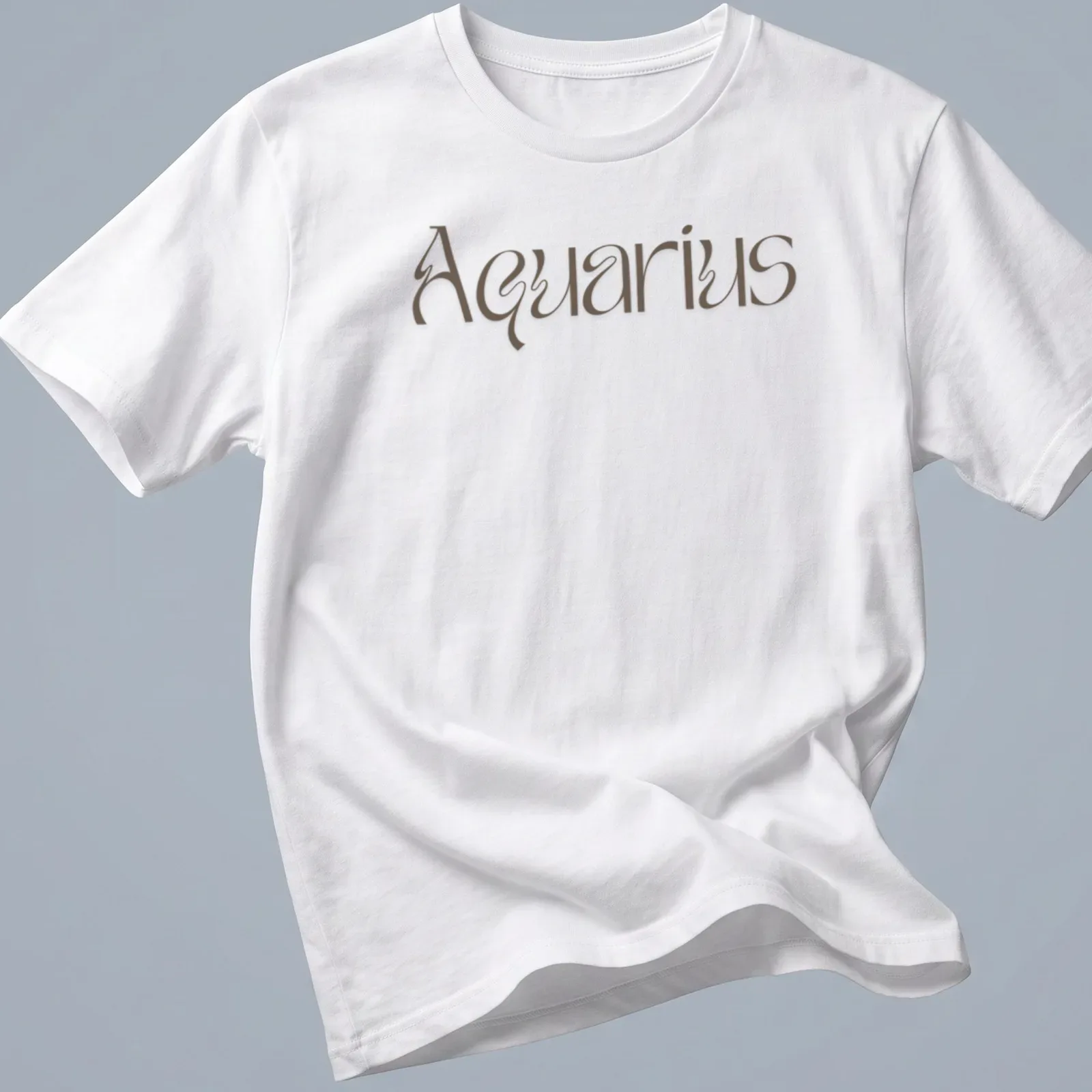 Elegant script reading Aquarius in brown on a celestial-themed — printed on a unisex t-shirt