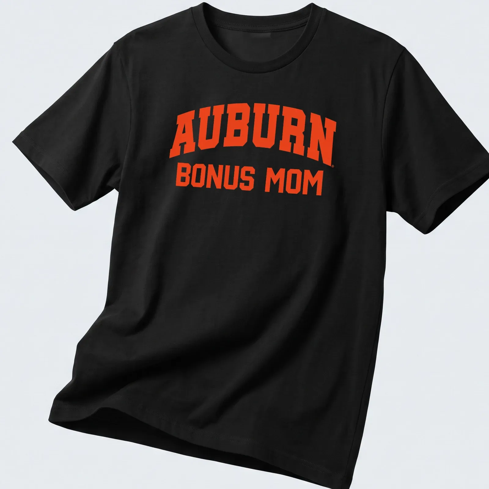 Bold collegiate Auburn Bonus Mom shirt in vibrant orange — printed on a unisex t-shirt