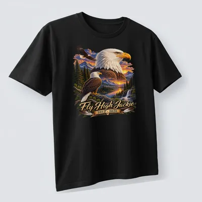 Realistic print of a Bald Eagle with text honoring Jackie 2012-2026 — printed on a unisex t-shirt (angled view)