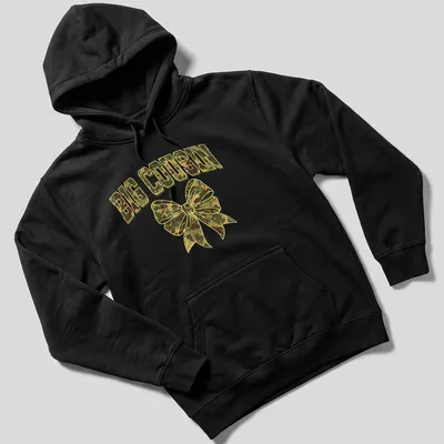 Cartoon style camouflage bow with bold 'BIG COUSIN' text in greens and browns — printed on a unisex hoodie