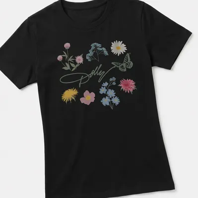 Charming pastel illustration of a butterfly and colorful flowers with Dolly signature — printed on a women's shirt