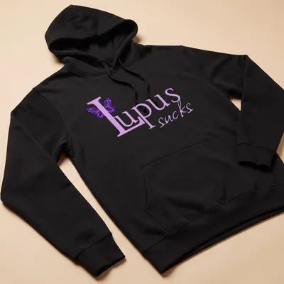 Illustration of a butterfly with the text 'Lupus sucks' in playful font. — printed on a unisex hoodie