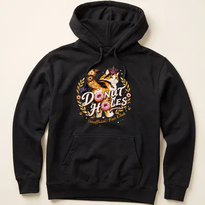 Colorful illustration of a calico cat with whimsical text about donut holes — printed on a unisex hoodie