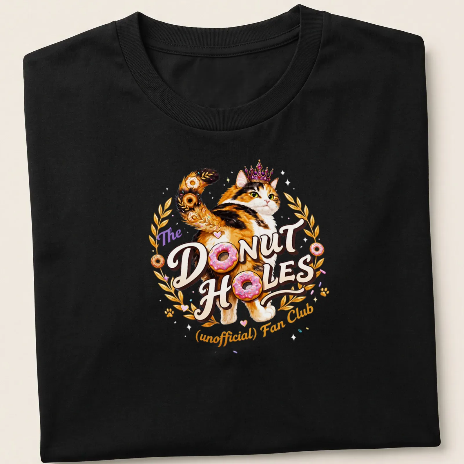Colorful illustration of a calico cat with whimsical text about donut holes — printed on a unisex t-shirt