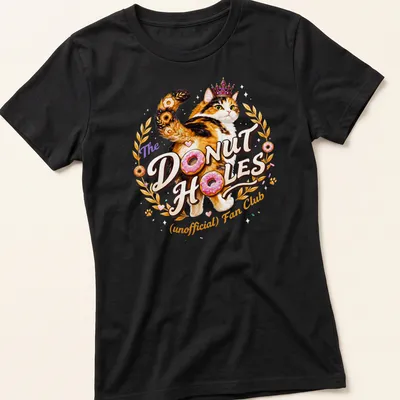Colorful illustration of a calico cat with whimsical text about donut holes — printed on a women's shirt