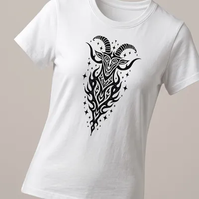 Bold tribal illustration of a Capricorn Sea Goat in black ink — printed on a women's shirt