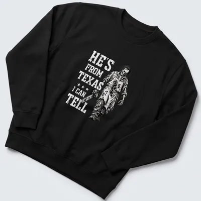 Chainsaw skeleton holding a chainsaw with text: He's From Texas I Can Tell. — printed on a unisex sweatshirt