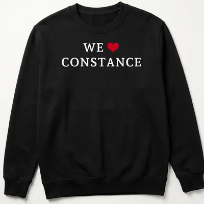 Simple text shirt that reads 'WE ♥ CONSTANCE' in red and white — printed on a unisex sweatshirt