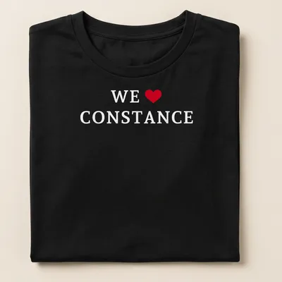 Simple text shirt that reads 'WE ♥ CONSTANCE' in red and white — printed on a women's shirt