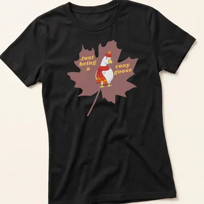 Cartoonish design of a cozy goose with playful text, warm colors — printed on a women's shirt