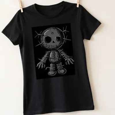 Gothic poppet doll illustration with pins in black, white, and gray — printed on a women's shirt