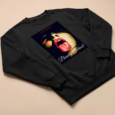 Vibrant art of a woman with red lips and tongue out, above Deftones Beauty School text — printed on a unisex sweatshirt