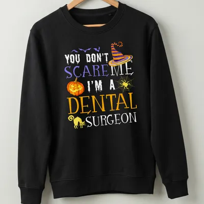 Whimsical Halloween shirt featuring a dental surgeon with playful text. — printed on a unisex sweatshirt