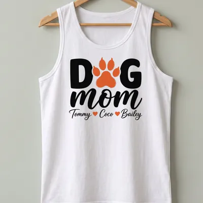 Black, orange, and white typography T-shirt with paw print and dog mom text. — printed on a tank top