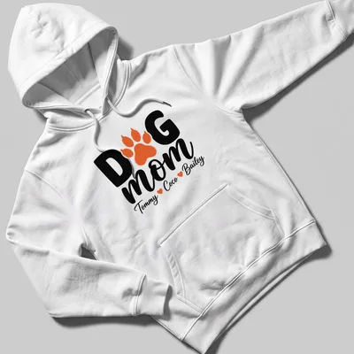 Black, orange, and white typography T-shirt with paw print and dog mom text. — printed on a unisex hoodie