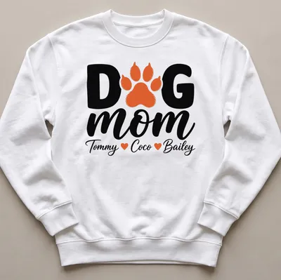 Black, orange, and white typography T-shirt with paw print and dog mom text. — printed on a unisex sweatshirt