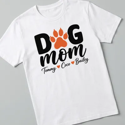 Black, orange, and white typography T-shirt with paw print and dog mom text.