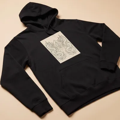 Intricate line-art of two dragons entwined around a Bodhi leaf in cream and beige on a black background. — printed on a unisex hoodie