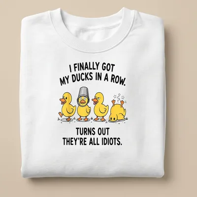 Cartoon design featuring yellow ducks with humorous text about organizing them. — printed on a unisex sweatshirt