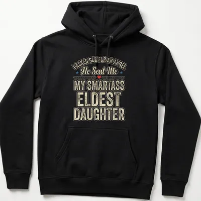 Playful typography t-shirt featuring humorous angel reference for eldest daughters — printed on a unisex hoodie