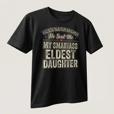 Playful typography t-shirt featuring humorous angel reference for eldest daughters — printed on a unisex t-shirt (angled view)