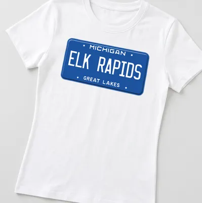 Vintage-style Elk Rapids Michigan T-shirt featuring license plate design — printed on a women's shirt