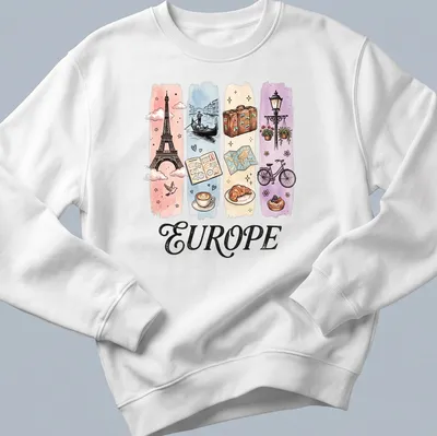 Illustrative watercolor design featuring Eiffel Tower, coffee, and croissant with 'EUROPE' text. — printed on a unisex sweatshirt