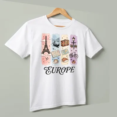 Illustrative watercolor design featuring Eiffel Tower, coffee, and croissant with 'EUROPE' text. — printed on a unisex t-shirt (angled view)