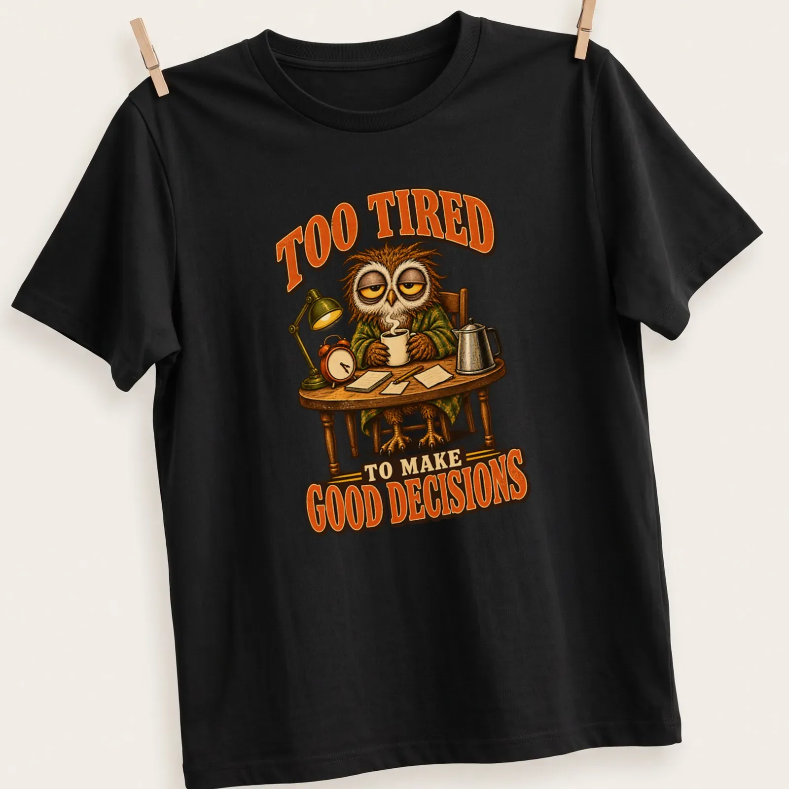 Vintage cartoon owl with text saying 'Too Tired To Make Good Decisions' in brown, orange, and cream — printed on a unisex t-shirt