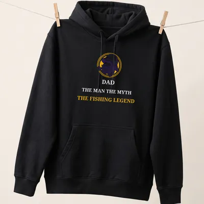 Vintage illustration of a fishing legend with the text 'THE FISHING LEGEND' in yellow, purple, and white. — printed on a unisex hoodie