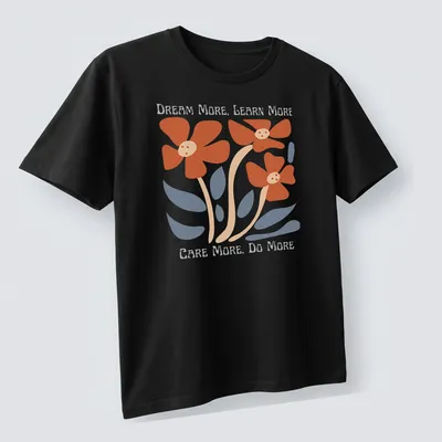 Colorful floral design featuring the text 'Dream More, Learn More, Care More, Do More' — printed on a unisex t-shirt (angled view)