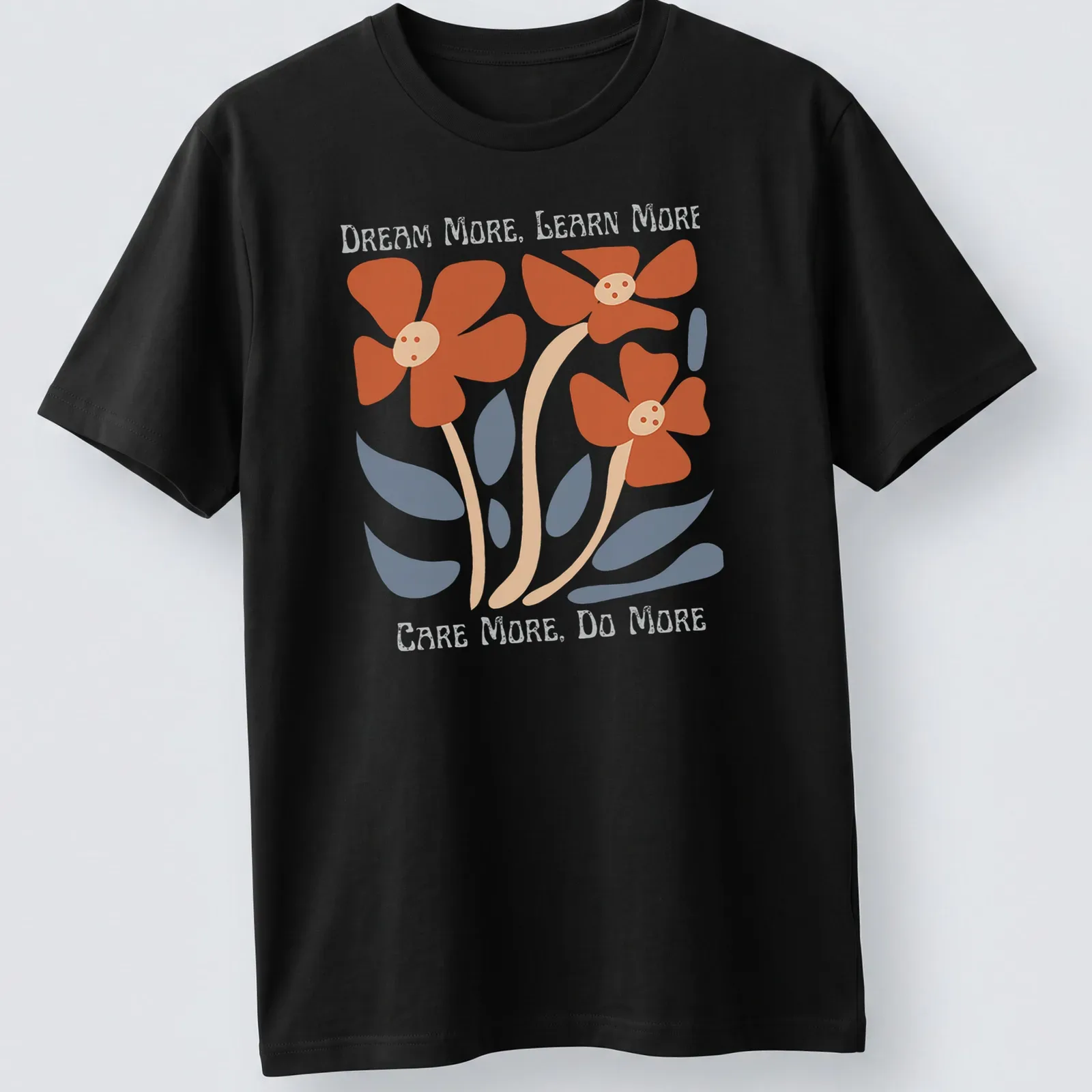 Colorful floral design featuring the text 'Dream More, Learn More, Care More, Do More' — printed on a unisex t-shirt