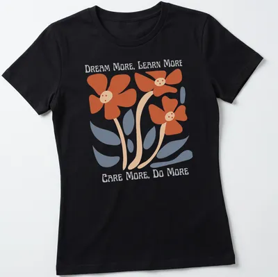 Colorful floral design featuring the text 'Dream More, Learn More, Care More, Do More' — printed on a women's shirt