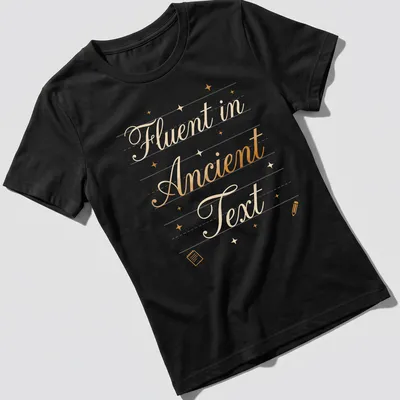 Elegant script of 'Fluent in Ancient Text' in gold on white — printed on a women's shirt
