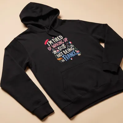 Cute and colorful illustration of France with Eiffel Tower and pastries — printed on a unisex hoodie