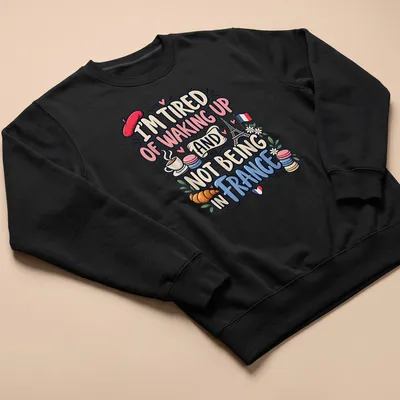 Cute and colorful illustration of France with Eiffel Tower and pastries — printed on a unisex sweatshirt