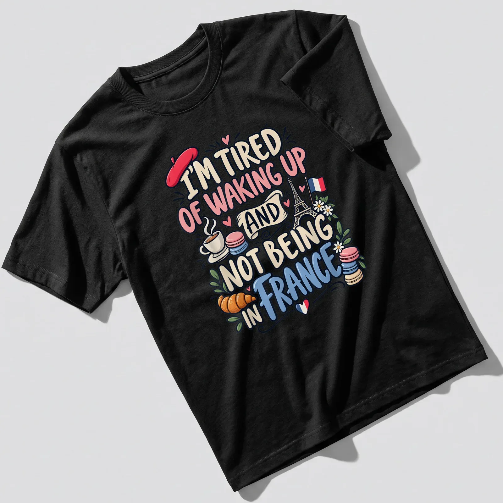 Cute and colorful illustration of France with Eiffel Tower and pastries — printed on a unisex t-shirt