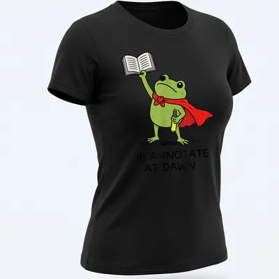 Cartoon frog T-shirt with the phrase 'We Annotate At Dawn' in playful font — printed on a women's shirt