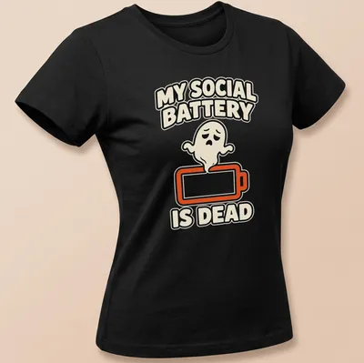 Cartoon ghost design with text 'MY SOCIAL BATTERY IS DEAD' in black and orange — printed on a women's shirt