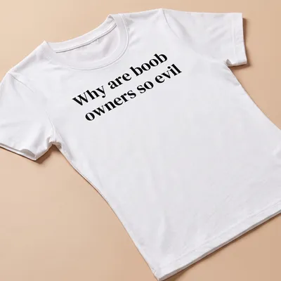 Bold typography t-shirt with the text 'Why are boob owners so evil' in black and white. — printed on a women's shirt