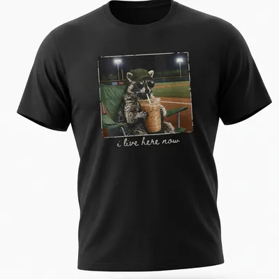Vintage distressed print of a playful raccoon with the text 'i live here now'