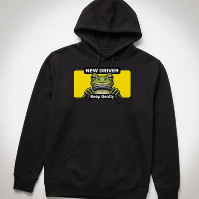 Cartoon green frog with text 'NEW DRIVER Beep Gently' in yellow and black — printed on a unisex hoodie